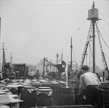 Possibly: Watering fish at the Fulton fish market with brine water, New York, 1943. Creator: Gordon Parks.