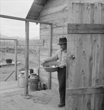 New settler shows fish he caught this morning, Priest River Valley, Bonner County, Idaho, 1939. Creator: Dorothea Lange.