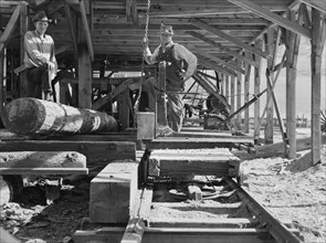 The sawmill carriage and log turner..., Ola self-help sawmill co-op, Gem County, Idaho, 1939. Creator: Dorothea Lange.