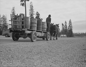 Farmer and his boy hauling water for drinking and domestic purposes..., Boundary County, Idaho, 1939 Creator: Dorothea Lange.