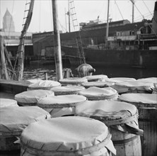 Barrels of fish on the docks at the Fulton fish market ready to be shipped to..., New York, 1943. Creator: Gordon Parks.