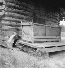 Tobacco barn with tobacco sled and vehicle used..., Person County, North Carolina, 1939. Creator: Dorothea Lange.