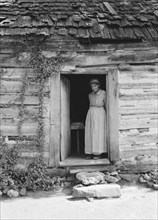 Caroline Atwater standing in the kitchen doorway of...log house, North Carolina, 1939. Creator: Dorothea Lange.