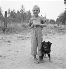 Migrant boy, family, live in grower's camp for..., near Grants pass, Josephine County, Oregon, 1939. Creator: Dorothea Lange.