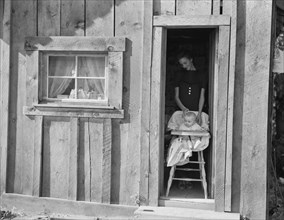 Wife and baby of president of Ola self-help sawmill co-op..., Gem County, Idaho, 1939. Creator: Dorothea Lange.