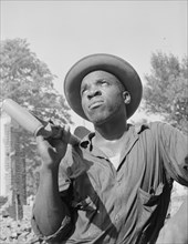 Laborer listening to instructions of wrecking company foreman..., Washington, D.C, 1942. Creator: Gordon Parks.