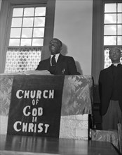 Elder Kelsey, pastor of the Church of God in Christ, opening a service..., Washington, D.C., 1942. Creator: Gordon Parks.