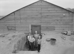 The Free children in doorway of their home in Sunday clothes. Dead Ox Flat, Malheur County, Oregon.
