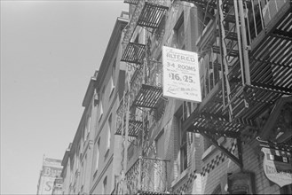 New York, New York. 61st Street between 1st and 3rd Avenues. A sign offering apartments for rent.