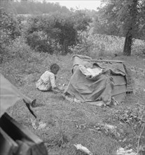 Tobacco sharecropper child playing. Note burlap covered playhouse. Person County, North Carolina.