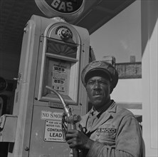 [Untitled photo, possibly related to: Washington, D.C. Negro mechanic for the Amoco oil company].