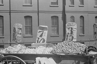 New York. New York, 61st Street between 1st and 3rd Avenues. A fruit and vegetable vendor stand.