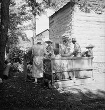 Families stringing tobacco brought in from the field by sled. Granville County, North Carolina.