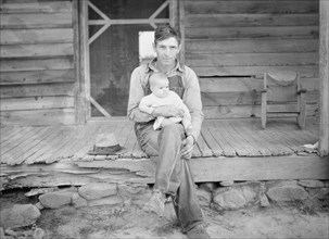 Mr. Whitfield, tobacco sharecropper, with baby on front porch. North Carolina, Person County.