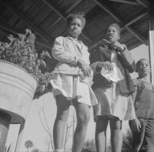 Daytona Beach, Florida. Two sisters with their brother on the front porch of the family home.