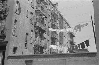New York, New York. 61st Street between 1st and 3rd Avenues. Apartment houses from the rear.