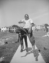 Anacostia, D.C. Frederick Douglass housing project. Boys playing leap frog near the project.