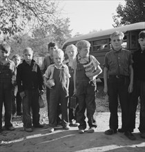 The children from Dead Ox Flat get off bus at school yard. Ontario, Malheur County, Oregon.