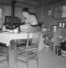 Mrs. Wardlow bakes her own bread in her dugout house. Dead Ox Flat, Malheur County, Oregon.