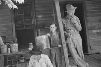 Bud Fields, Tengle boy, and Floyd Burroughs on Frank Tengle's porch, Hale County, Alabama.