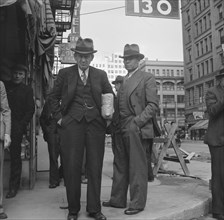 Salvation Army, San Francisco, California. Men pause a moment to watch, and then pass on.