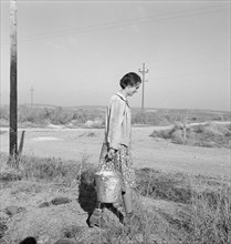 Mrs. Bartheloma hauls water from irrigation ditch. Nyssa Heights, Malheur County, Oregon.