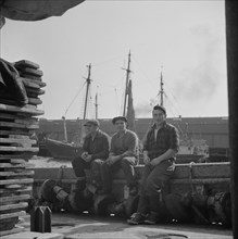 New York, New York. Gloucester fishermen resting on their boat at the Fulton fish market.