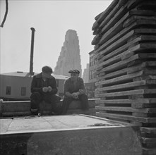 New York, New York. Gloucester fishermen resting on their boat at the Fulton fish market.