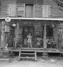 Daughter of white tobacco sharecropper at country store. Person County, North Carolina.