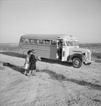 Dead Ox Flat. Children get into school bus on a fall morning. Malheur County, Oregon.