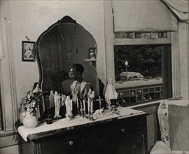 Washington, D.C. Dresser in the bedroom of Mrs. Ella Watson, a government charwoman.