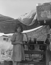 Migratory child at end of day in bean pickers' camp near West Stayton, Oregon.