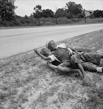 White and Negro boy wrestling by side of road. Person County, North Carolina.