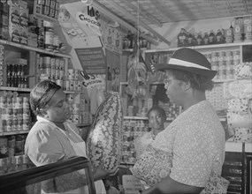 Washington, D.C. Housewife bargaining in the store owned by Mr. J. Benjamin.