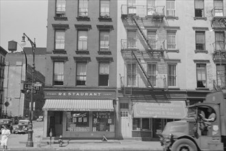 New York, New York. 61st Street between 1st and 3rd Avenues. House fronts.