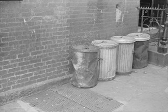 New York, New York. 61st Street between 1st and 3rd Avenues. Garbage cans.