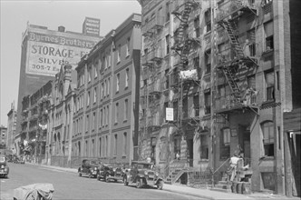 New York, New York. 61st Street between 1st and 3rd Avenues. House fronts.