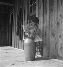 Daughter of Negro tenant churning butter. Randolph County, North Carolina.