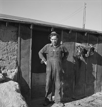 Mr. Roberts in front of his Owyhee project home. Malheur County, Oregon.