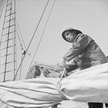 A New England fisherman preparing his boat to leave the New York docks.