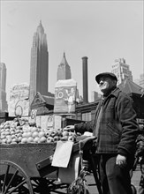 New York, New York. Push cart fruit vendor at the Fulton fish market.