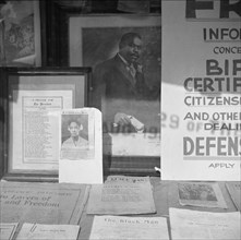 Signs in the windows of a Marcus Garvey club in the Harlem area.