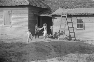 Burroughs children playing in the yard, Hale County, Alabama.