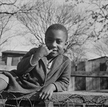 Washington (southwest section), D.C. Boy playing on a fence.