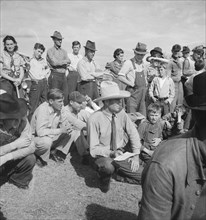 Watching ball game. Shafter camp for migrants. California.