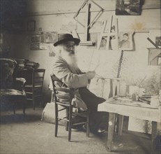 Camille Pissarro painting in his studio, c1860-1903.