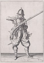 A soldier pouring powder into the pan, from the Marksmen series, plate 16, in Wa..., published 1608. Creator: Robert Willemsz de Baudous.