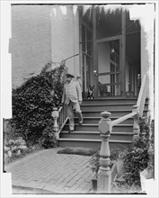 Admiral George Dewey on steps of house, Washington D.C., between 1890 and 1910. Creator: Levin Handy.