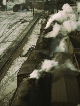 Locomotives lined up for coal, sand and water at the coaling station in the 40..., Chicago, 1942. Creator: Jack Delano.