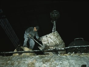 Spreading asbestos mixture on boiler of a locomotive, C & NW RR, 40th Street locomotive shops, 1942. Creator: Jack Delano.